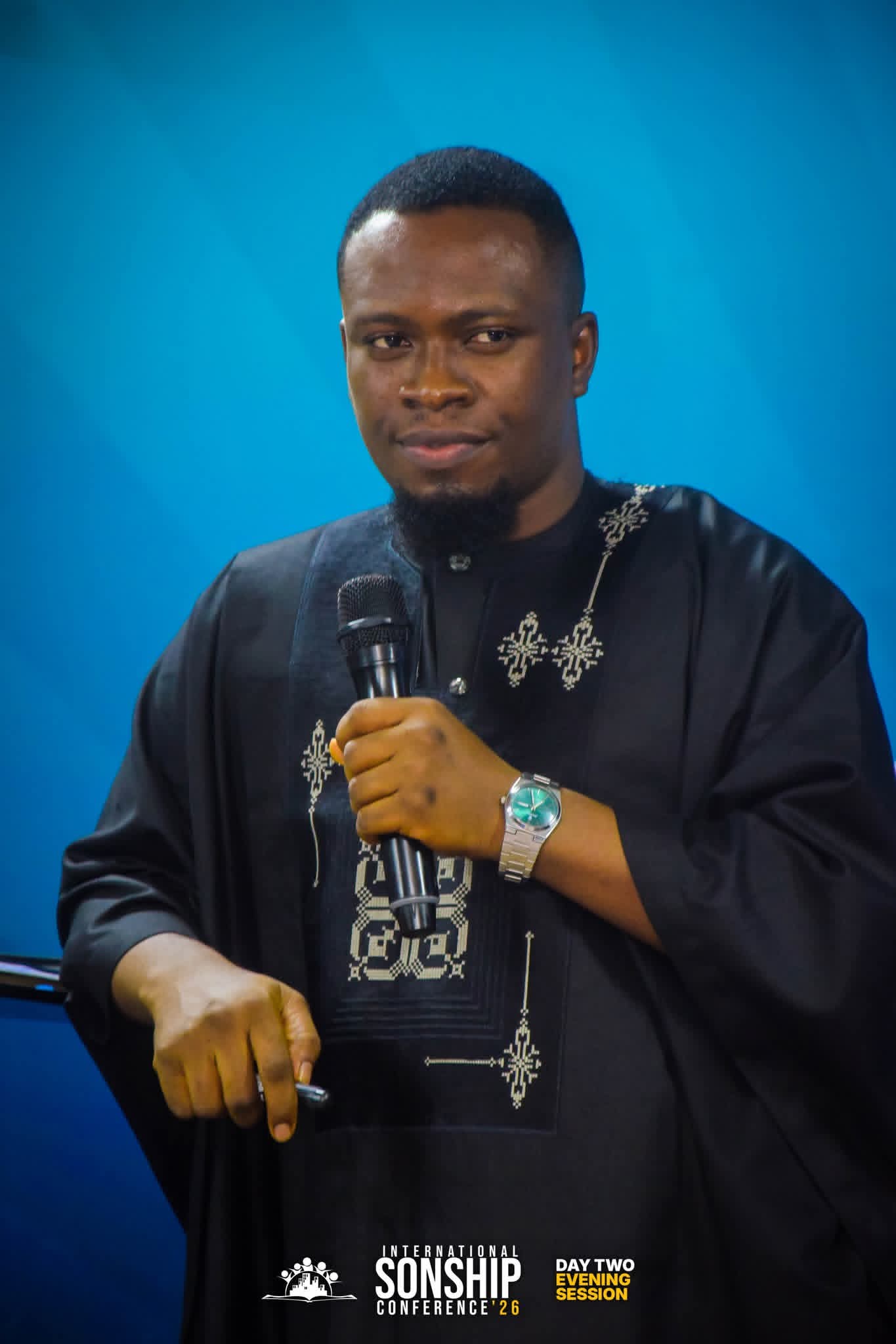 Pastor Samuel leading congregation in worship